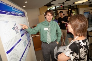 Garrett Johnson '12 explains his chemistry research at a symposium last spring