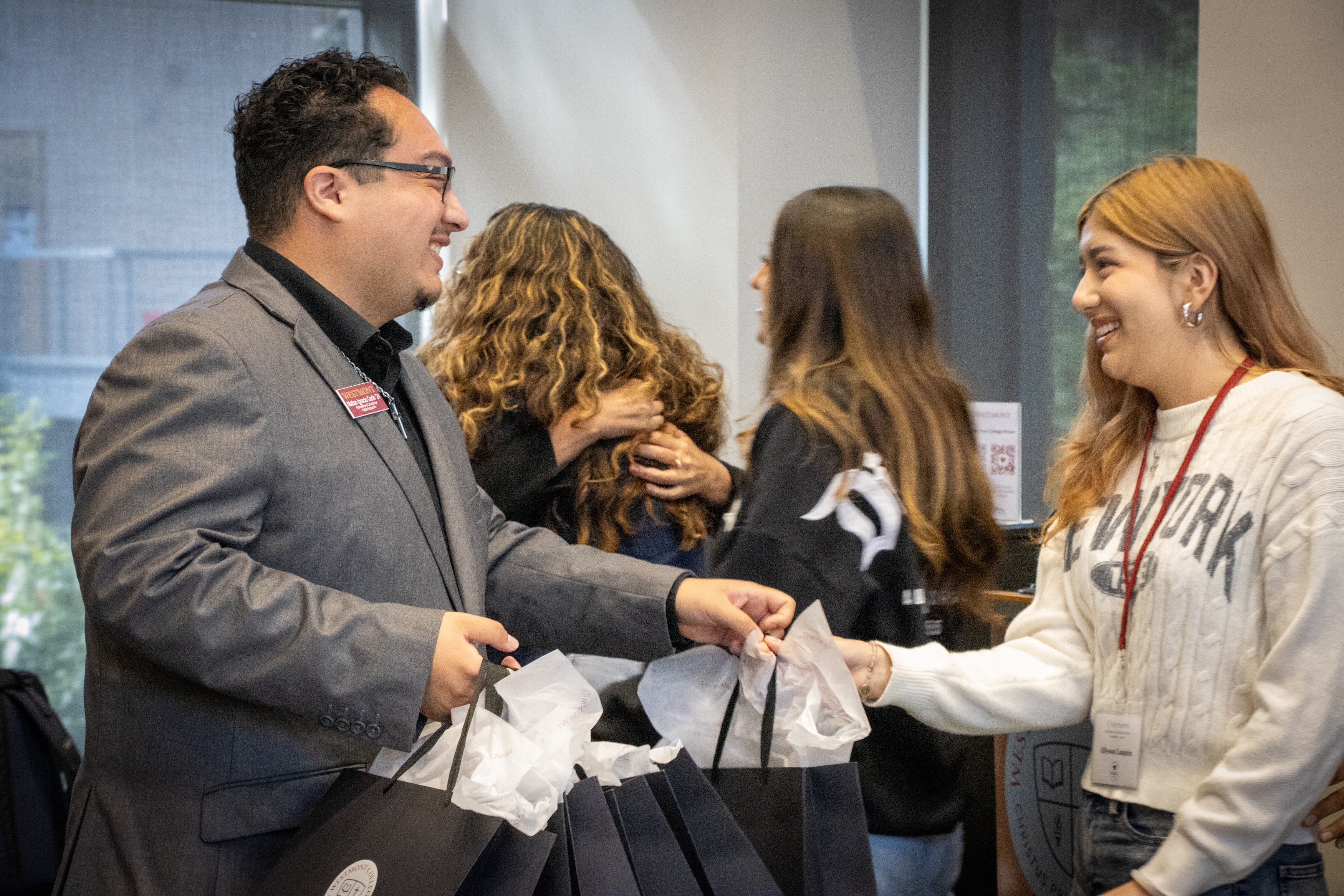 westmont counselor giving out goodie bag to guest