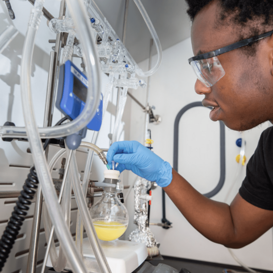 male chemistry student experimenting in lab